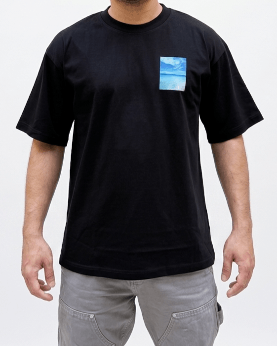 Close-up of black oversized T-shirt with minimal blue graphic print