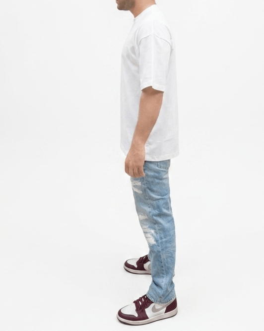 Side view of white unisex oversized blue and orange graphic T-shirt