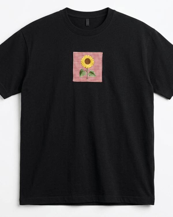 Black oversized unisex T-shirt featuring floral embroidery on premium cotton fabric with a relaxed streetwear fit.