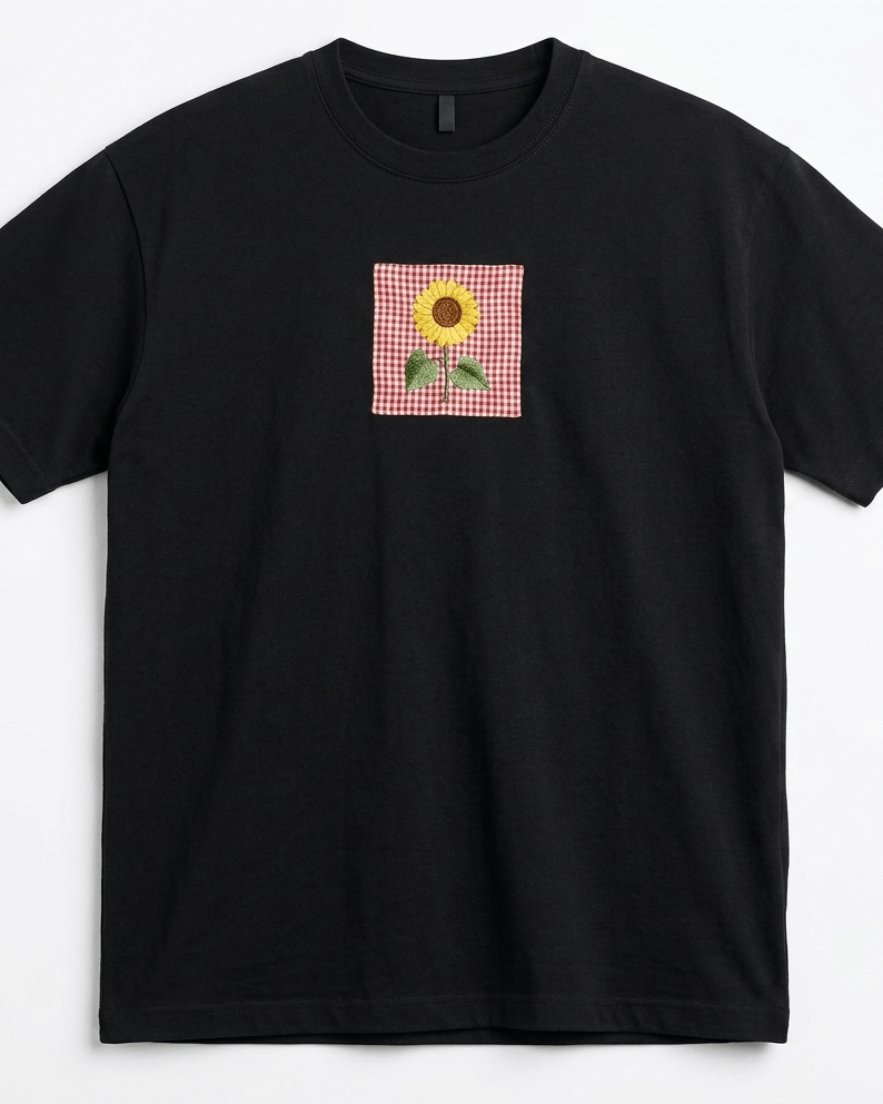 Black oversized unisex T-shirt featuring floral embroidery on premium cotton fabric with a relaxed streetwear fit.